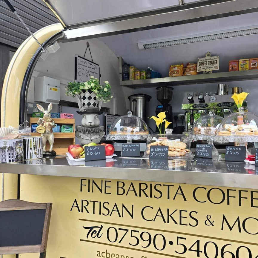 The inside of AC Signature Coffee Beans Trailer showing a range of delicious traybakes and artisan cakes which are available for sale. 